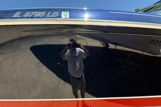 Slide: The Image of 2015 Formula 350 Crossover Bowrider boat on stands, featuring sleek design and American flag. - 46