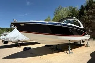 Slide: The Image of 2015 Formula 350 Crossover Bowrider on stands, outdoors, under clear blue sky. - 5