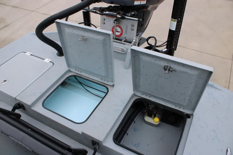 Slide: The Image of Open compartments on a 2026 Freedom Boats 24 Defender, showcasing storage and engine access. - 10