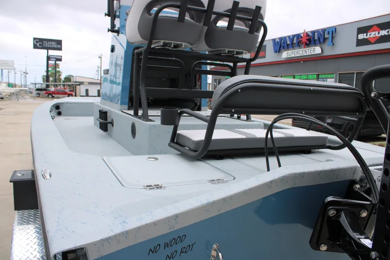 Slide: The Image of 2026 Freedom Boats 24 Defender at dealership, showcasing seating and deck features. - 11