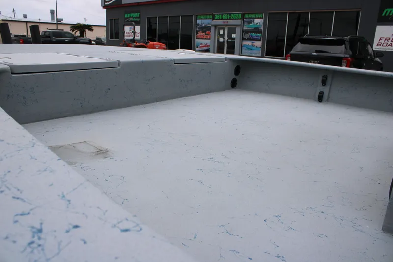 Slide: The Image of 2026 Freedom Boats 24 Defender interior with spacious deck, parked outside dealership. - 12