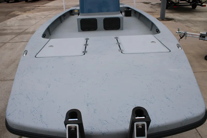 Slide: The Image of 2026 Freedom Boats 24 Defender, spacious deck view, light blue finish, docked outdoors. - 14