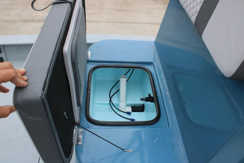 Slide: The Image of Open storage compartment on 2026 Freedom Boats 24 Defender, showcasing interior features. - 16