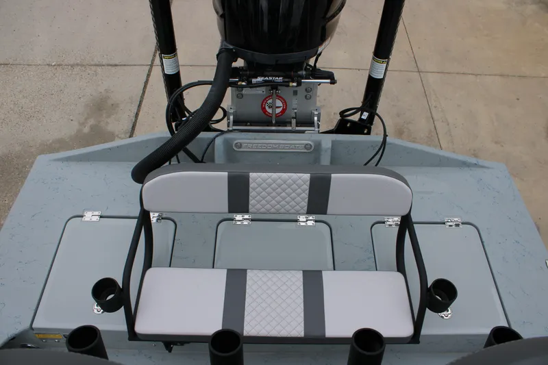 Slide: The Image of 2026 Freedom Boats 24 Defender interior with seating and motor, showcasing modern design. - 19