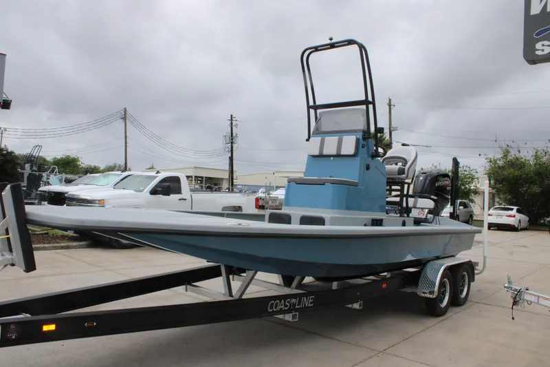 Slide: The Image of 2026 Freedom Boats 24 Defender on trailer, parked outdoors under cloudy sky. - 3