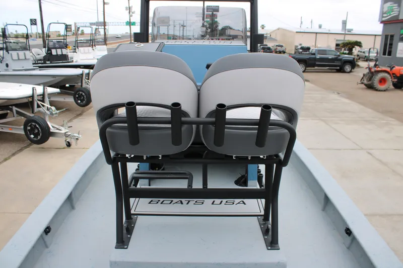Slide: The Image of 2026 Freedom Boats 24 Defender with dual seats and rod holders, displayed at a dealership. - 5