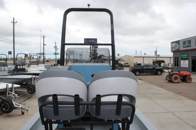 Slide: The Image of 2026 Freedom Boats 24 Defender at dealership, showcasing rear seating and console. - 6