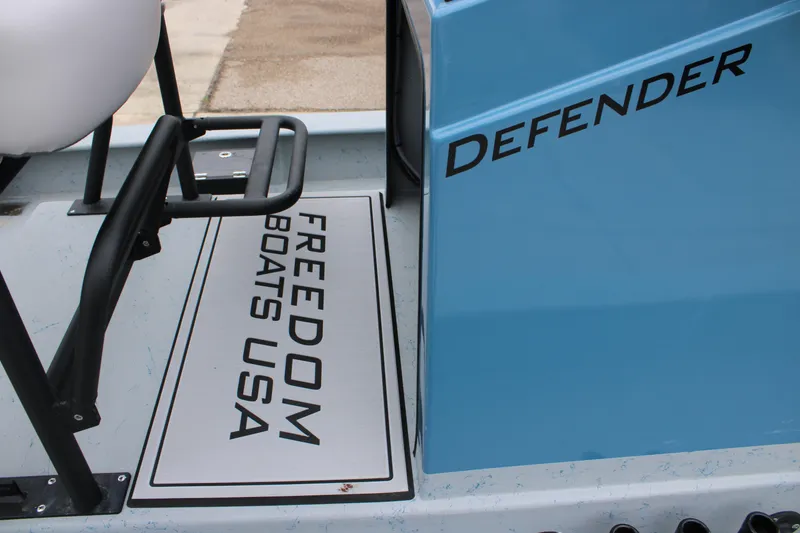 Slide: The Image of 2026 Freedom Boats 24 Defender, blue exterior with branding details. - 7