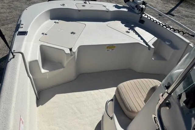 Slide: The Image of 2015 Carolina Skiff 198 DLV boat interior with seating and storage compartments. - 15