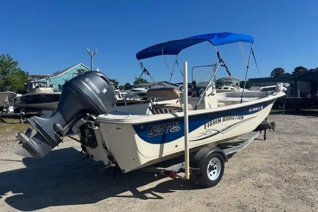 Slide: The Image of 2015 Carolina Skiff 198 DLV boat with Yamaha motor and blue canopy on trailer. - 4