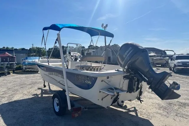 Slide: The Image of 2015 Carolina Skiff 198 DLV boat with Yamaha outboard motor and blue canopy. - 6