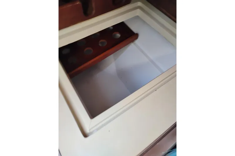 Slide: The Image of Interior view of 1982 Ericson 25 sailboat storage compartment with wooden divider. - 15