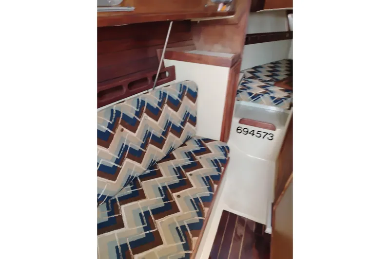 Slide: The Image of Interior of 1982 Ericson 25 sailboat with patterned seating and wooden accents. - 18