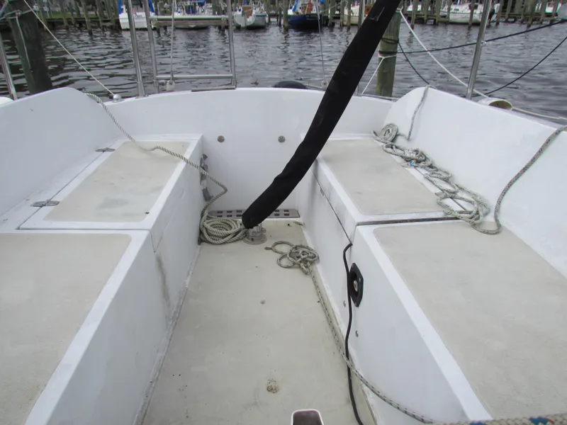 Slide: The Image of 1982 Ericson 25 sailboat cockpit with ropes and seating, docked at marina. - 3