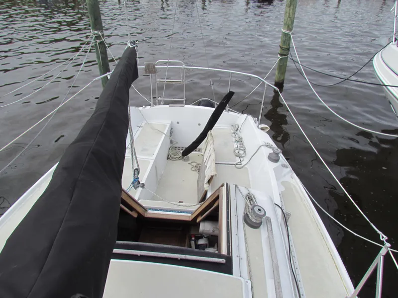 Slide: The Image of 1982 Ericson 25 sailboat docked, showing cockpit and rigging details. - 6