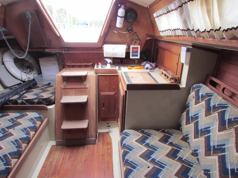 Slide: The Image of Interior of 1982 Ericson 25 sailboat with patterned seating and wooden cabinetry. - 8