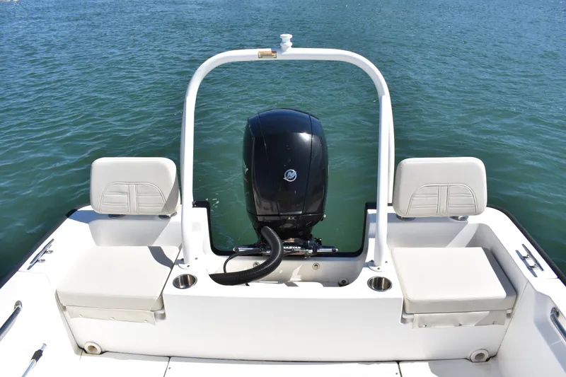 Slide: The Image of 2022 Boston Whaler 190 Montauk boat with outboard motor on calm water. - 12