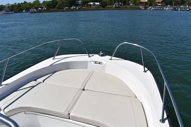 Slide: The Image of 2022 Boston Whaler 190 Montauk boat on calm water, featuring spacious bow seating. - 6