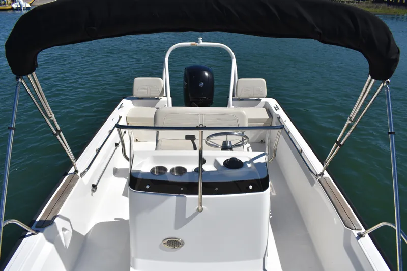 Slide: The Image of 2022 Boston Whaler 190 Montauk boat interior with steering console and seating. - 7