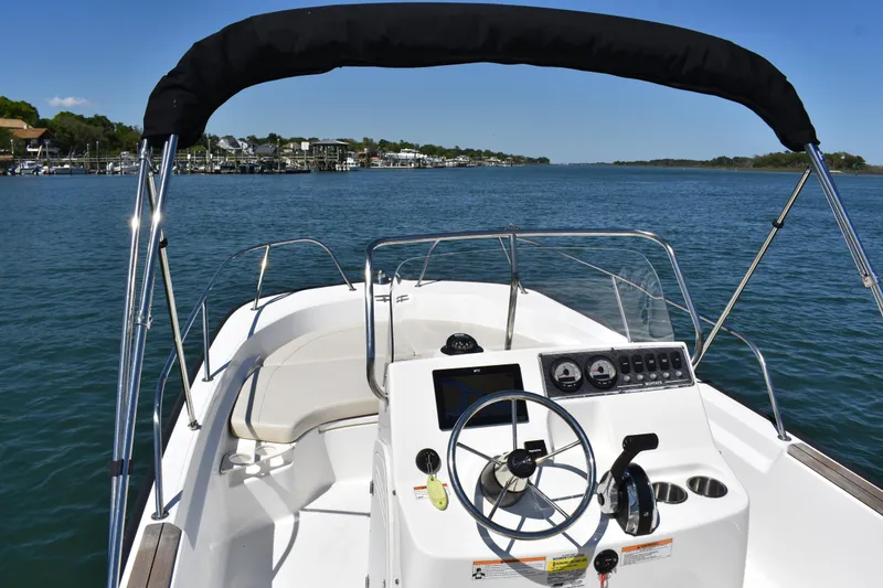 Slide: The Image of 2022 Boston Whaler 190 Montauk boat on calm water with clear blue sky. - 8