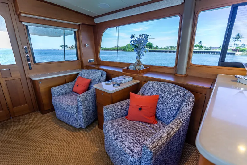 Slide: The Image of Luxurious 2018 Grand Banks GB60 yacht interior with cozy seating and scenic ocean views. - 25