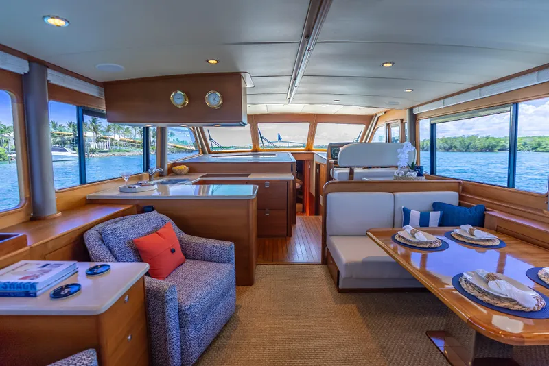 Slide: The Image of Luxurious 2018 Grand Banks GB60 yacht interior with elegant dining and seating area, overlooking serene waters. - 3