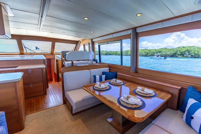 Slide: The Image of Luxurious 2018 Grand Banks GB60 yacht interior with elegant dining area and scenic ocean view. - 32