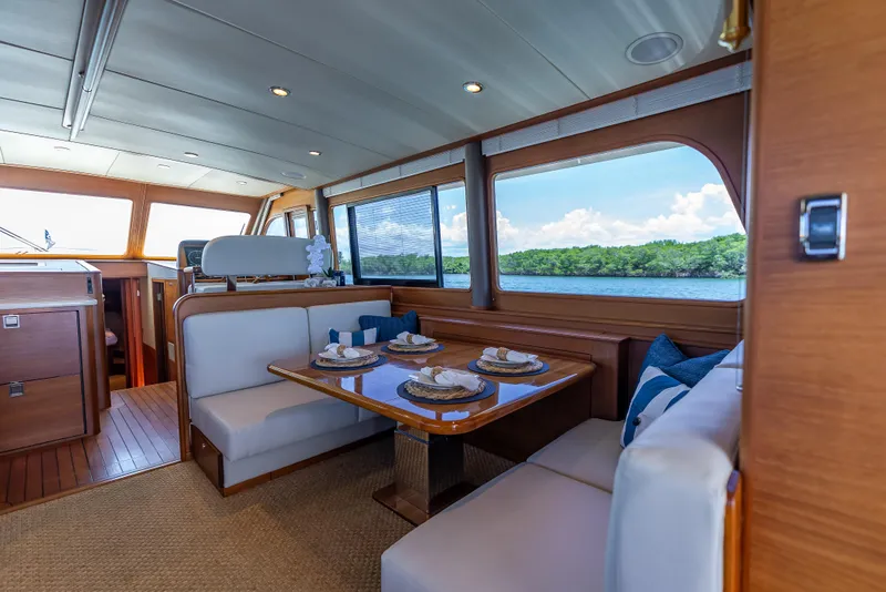 Slide: The Image of Luxurious 2018 Grand Banks GB60 yacht interior with elegant dining area and scenic water views. - 33