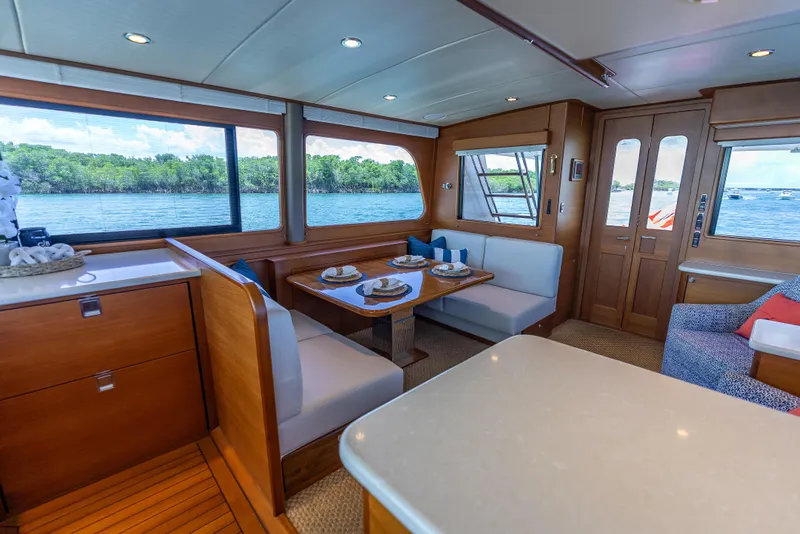 Slide: The Image of Luxurious 2018 Grand Banks GB60 yacht interior with dining area and scenic water views. - 37