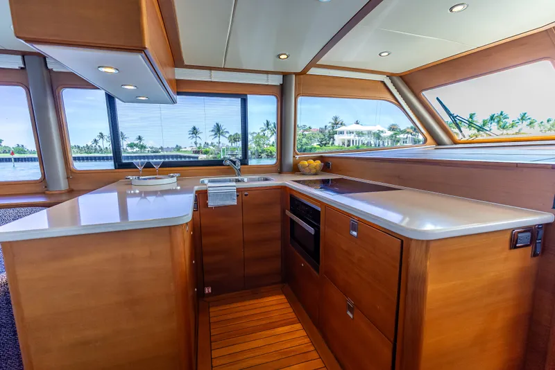 Slide: The Image of Luxurious 2018 Grand Banks GB60 yacht kitchen with modern amenities and scenic window views. - 41