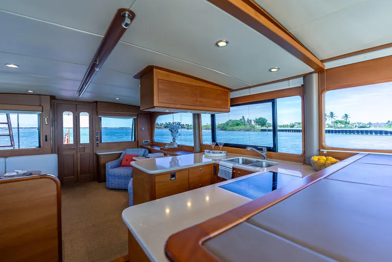 Slide: The Image of Luxurious 2018 Grand Banks GB60 yacht interior with modern kitchen and scenic ocean views. - 42