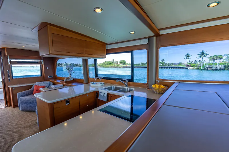 Slide: The Image of Luxurious 2018 Grand Banks GB60 yacht interior with modern kitchen and scenic water views. - 46
