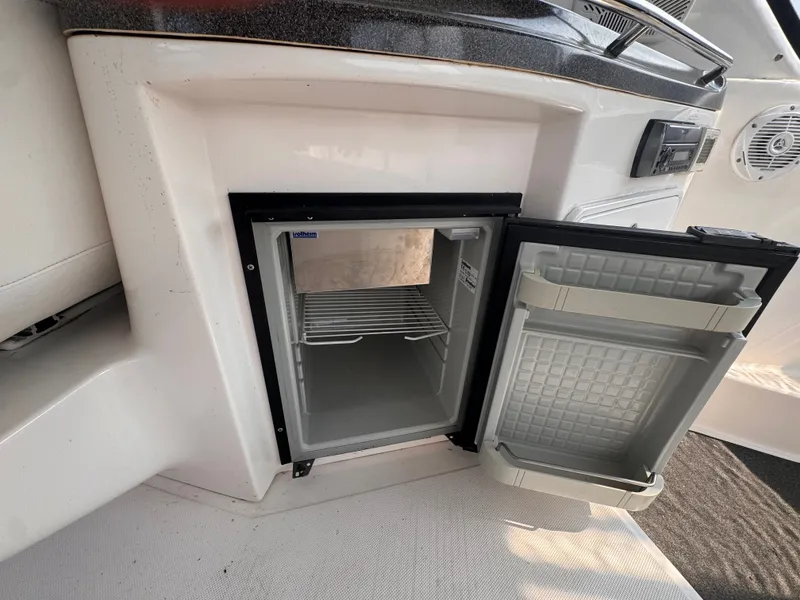 Slide: The Image of An open fridge on a 2006 Regal Commodore 3860, featuring a shelf and door storage. - 13