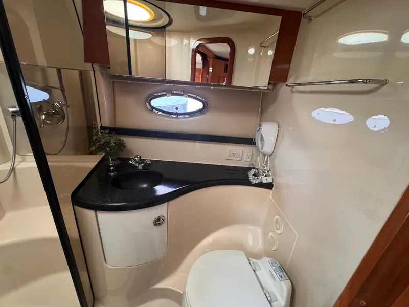 Slide: The Image of The image shows an elegant yacht bathroom with a sink, toilet, and mirror. - 25