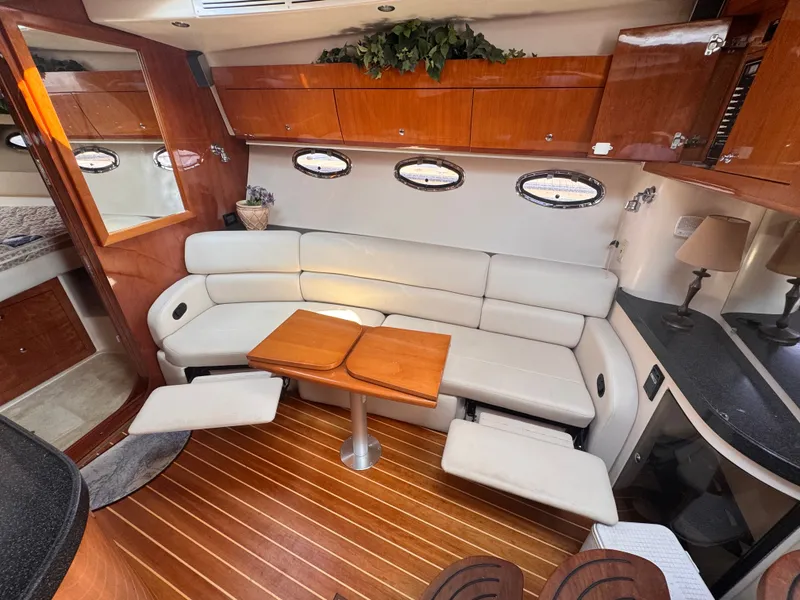 Slide: The Image of Interior of a 2006 Regal Commodore 3860 with elegant leather couch and wooden table. - 19