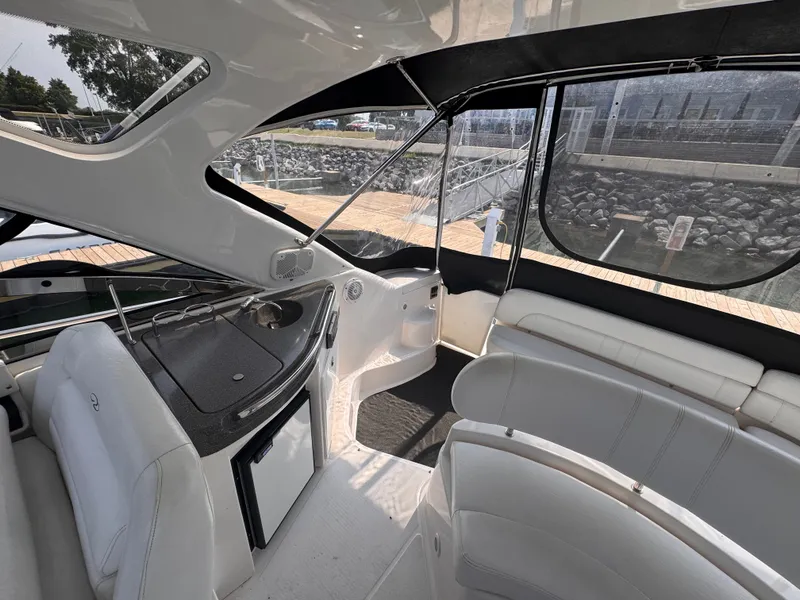 Slide: The Image of The image shows the cockpit of a 2006 Regal Commodore 3860 with white upholstery and a small fridge. - 5