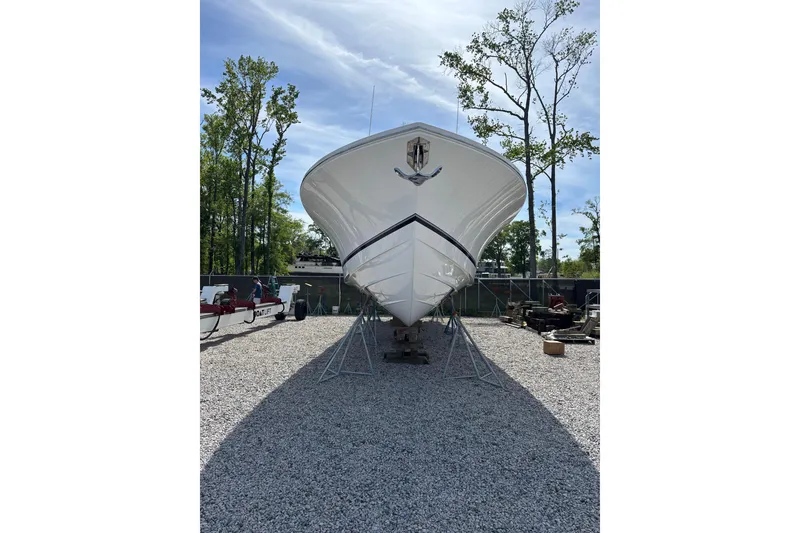 Slide: The Image of 2023 Regulator 41 boat on stands, displayed outdoors under a clear sky. - 11