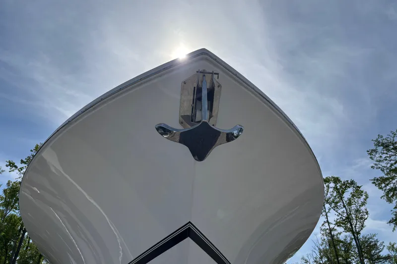 Slide: The Image of 2023 Regulator 41 boat bow under clear sky, showcasing sleek design and chrome anchor. - 12
