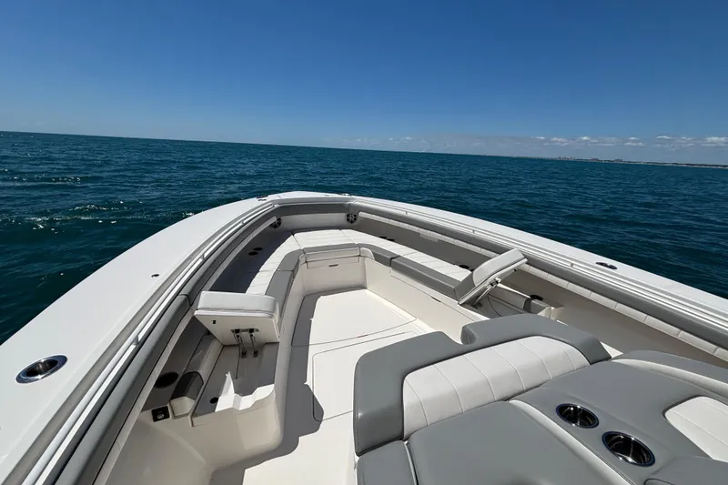 Slide: The Image of 2023 Regulator 41 boat on open sea, featuring spacious seating and sleek design. - 16