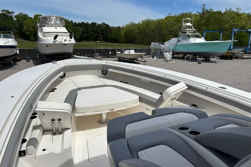 Slide: The Image of 2023 Regulator 41 boat with spacious seating, docked among other vessels. - 17