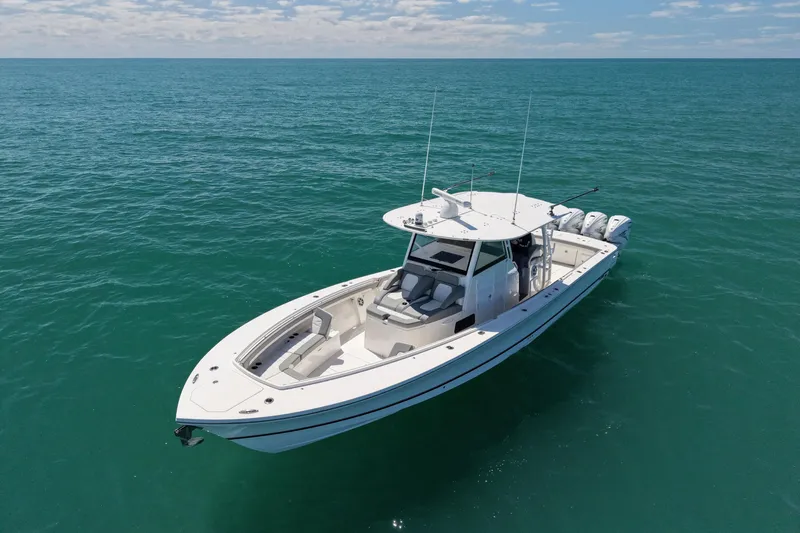 Slide: The Image of 2023 Regulator 41 boat on open ocean, clear skies, calm waters. - 2