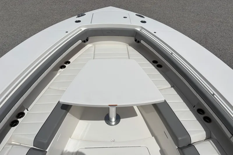 Slide: The Image of 2023 Regulator 41 boat interior with cushioned seating and table setup. - 20