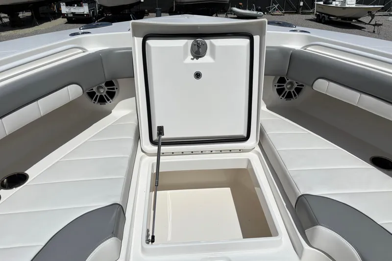 Slide: The Image of 2023 Regulator 41 boat interior with open storage compartment and cushioned seating. - 22