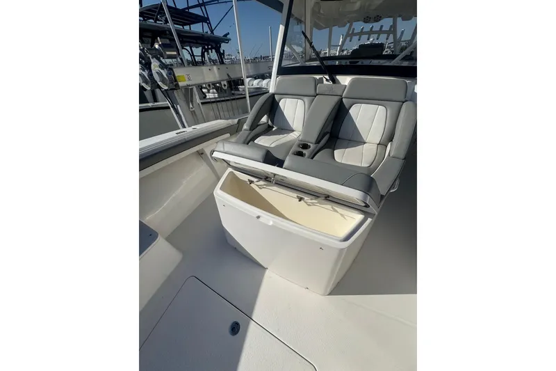 Slide: The Image of 2023 Regulator 41 boat interior with cushioned seating and storage compartment. - 25