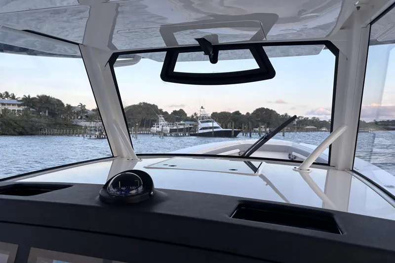 Slide: The Image of Interior view from a 2023 Regulator 41 boat, overlooking a marina with yachts. - 31