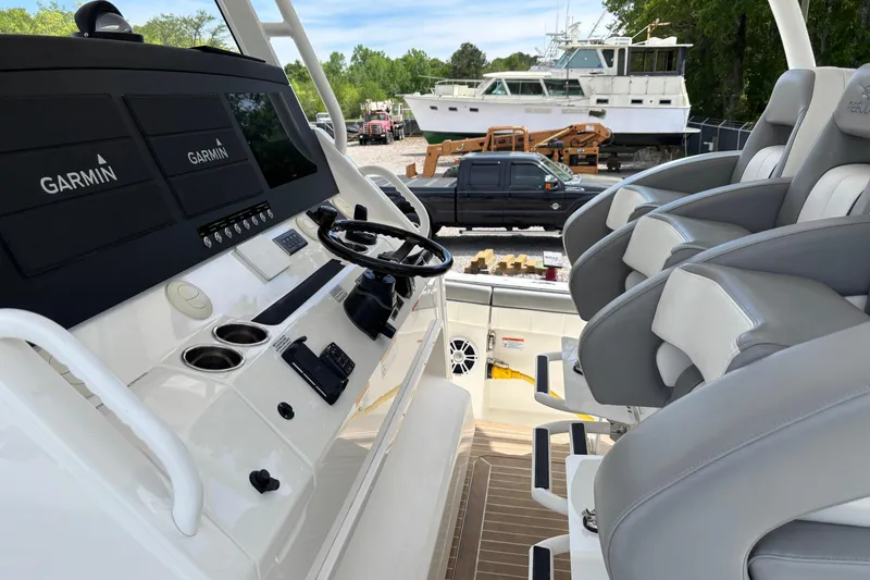 Slide: The Image of 2023 Regulator 41 boat cockpit with Garmin displays and luxurious seating. - 32