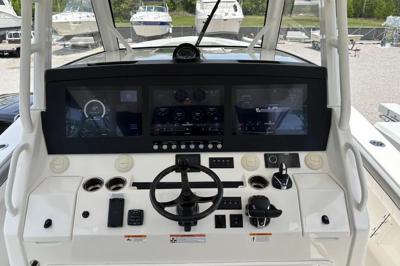 Slide: The Image of 2023 Regulator 41 boat dashboard with advanced navigation displays and controls. - 33
