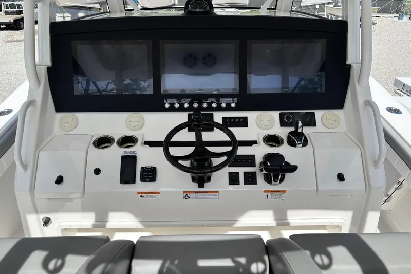 Slide: The Image of 2023 Regulator 41 boat dashboard with modern controls and dual display screens. - 34
