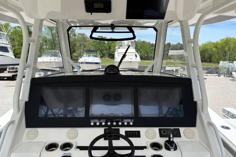 Slide: The Image of 2023 Regulator 41 boat dashboard with advanced navigation screens and controls. - 35
