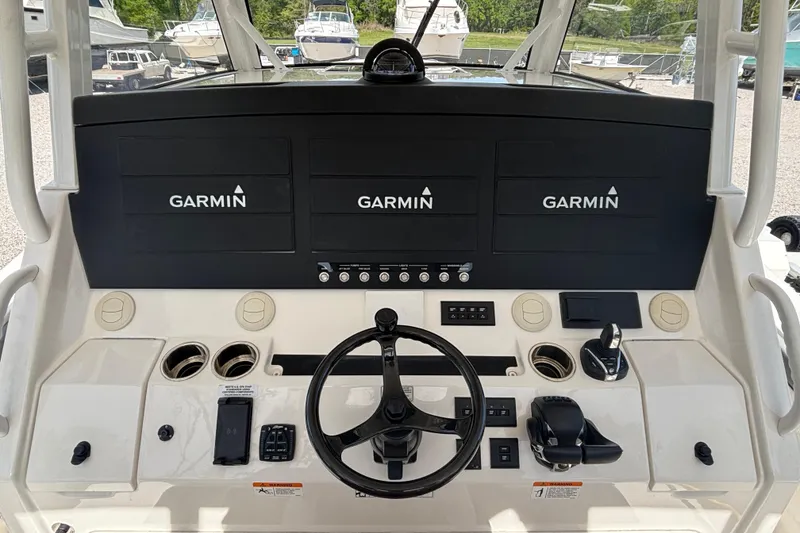 Slide: The Image of 2023 Regulator 41 boat dashboard with Garmin displays and steering wheel. - 37